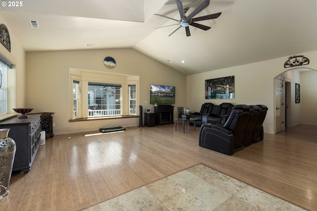 6783 Rogue River Dr, Shady Cove, OR 97539 - living area featuring a ceiling fan, arched walkways, lofted ceiling, and wood finished floors