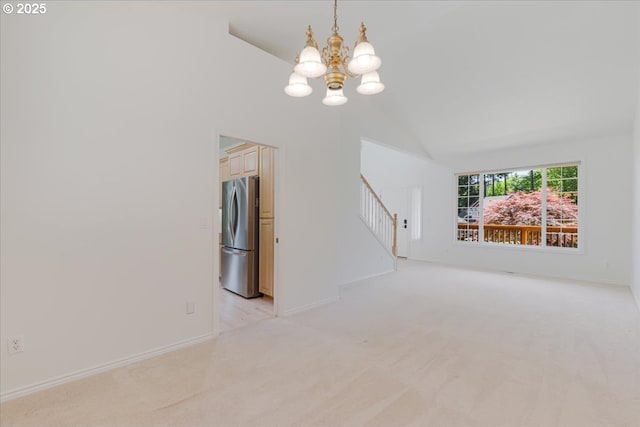 18169 SW Shady Meadow Ct, Beaverton, OR 97007 - spare room with a chandelier, light colored carpet, stairs, vaulted ceiling, and baseboards