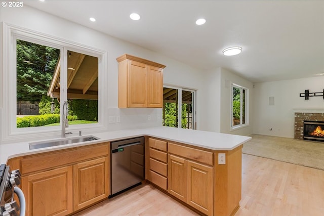 18169 SW Shady Meadow Ct, Beaverton, OR 97007 - kitchen with stainless steel dishwasher, a sink, a peninsula, light wood-type flooring, and recessed lighting
