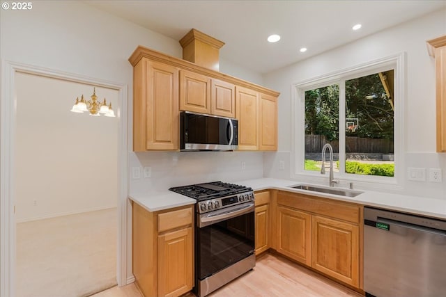 18169 SW Shady Meadow Ct, Beaverton, OR 97007 - kitchen featuring stainless steel appliances, a sink, light brown cabinetry, light countertops, and recessed lighting