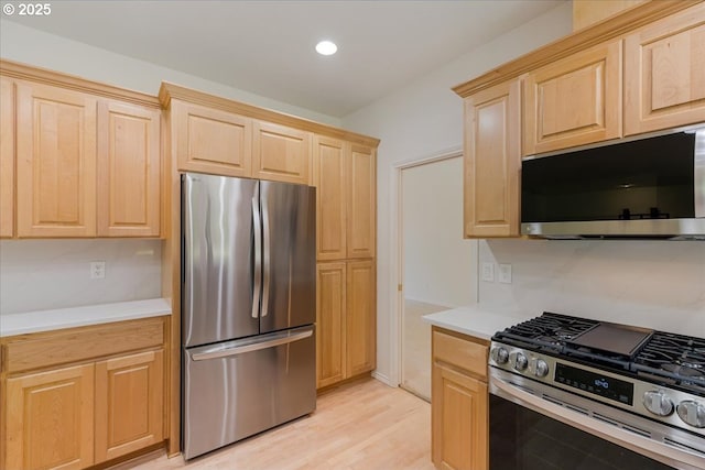 18169 SW Shady Meadow Ct, Beaverton, OR 97007 - kitchen featuring stainless steel appliances, light brown cabinets, light countertops, recessed lighting, and light wood-type flooring