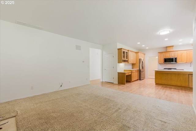 18169 SW Shady Meadow Ct, Beaverton, OR 97007 - unfurnished living room with light carpet, baseboards, and recessed lighting