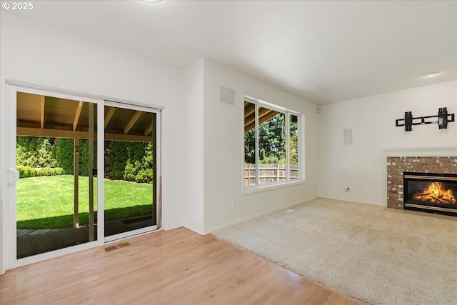 18169 SW Shady Meadow Ct, Beaverton, OR 97007 - unfurnished living room featuring wood finished floors, baseboards, and a fireplace