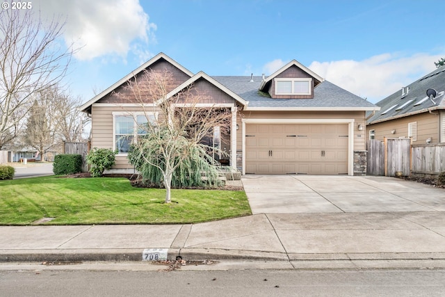 craftsman-style house featuring a garage and a front yard