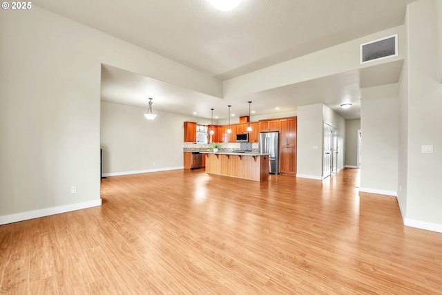 unfurnished living room featuring light wood-type flooring