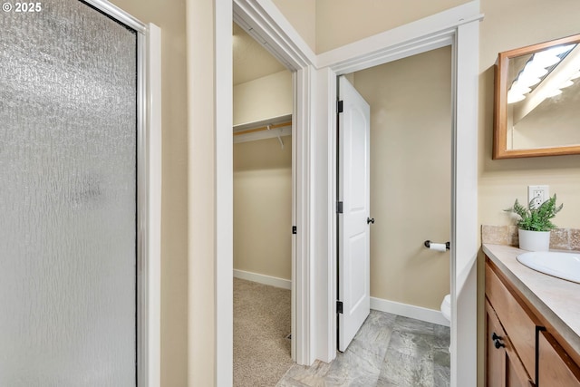 bathroom featuring vanity and an enclosed shower