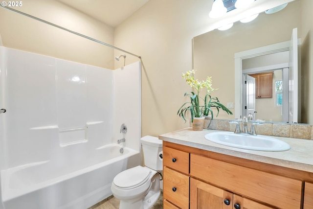 full bathroom featuring vanity, bathing tub / shower combination, and toilet