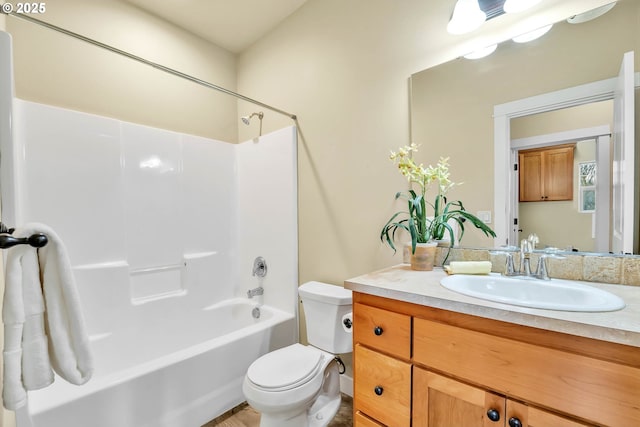 full bathroom featuring vanity, toilet, and  shower combination