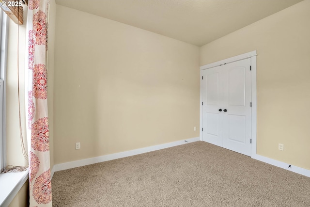 unfurnished bedroom with a closet and carpet