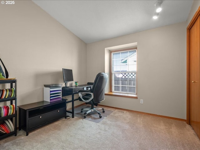 office space featuring vaulted ceiling and light colored carpet