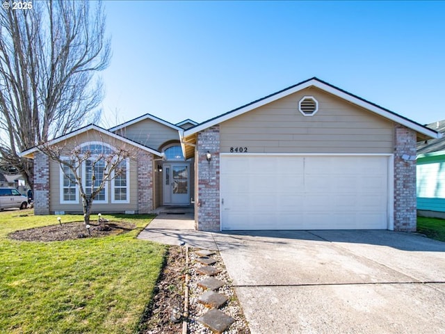 ranch-style home featuring a garage and a front yard