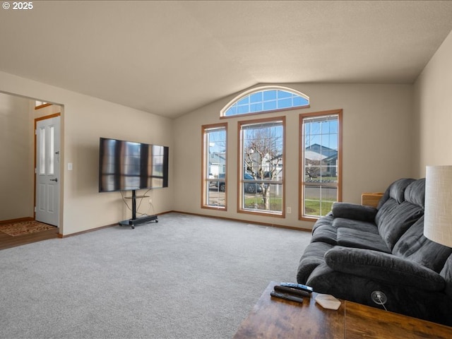 living room with vaulted ceiling and light colored carpet