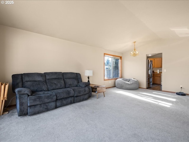 carpeted living room with lofted ceiling and a notable chandelier