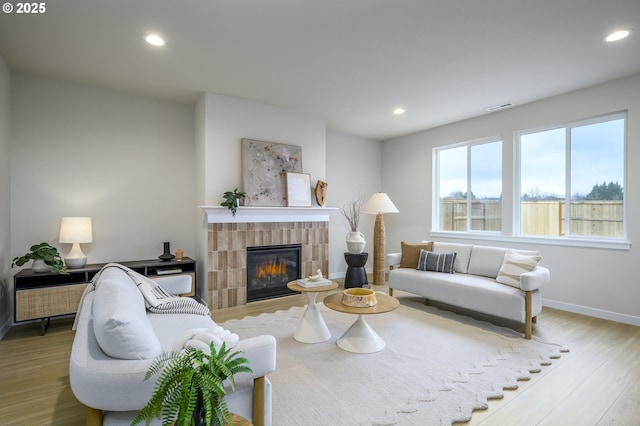 17269 SW Atfalati Ln Unit 36, Sherwood, OR 97140 - living room featuring wood finished floors, recessed lighting, and a glass covered fireplace