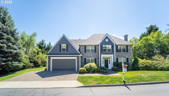 1811 NW Rosefinch Ln, Portland, OR 97229 - colonial house featuring driveway, a front yard, a chimney, a garage, and stone siding