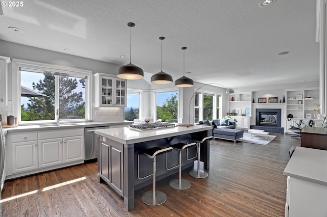 1811 NW Rosefinch Ln, Portland, OR 97229 - kitchen featuring appliances with stainless steel finishes, a sink, a textured ceiling, a kitchen island, and light countertops