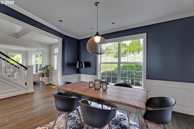 1811 NW Rosefinch Ln, Portland, OR 97229 - dining room with wainscoting, stairs, a textured ceiling, ornamental molding, and wood finished floors