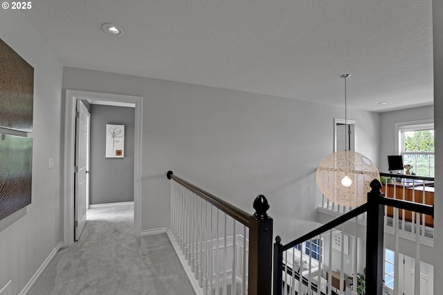 1811 NW Rosefinch Ln, Portland, OR 97229 - hallway featuring an upstairs landing, carpet floors, baseboards, a textured ceiling, and recessed lighting