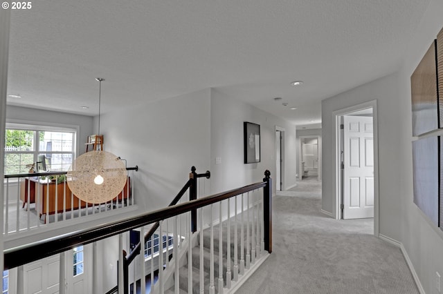 1811 NW Rosefinch Ln, Portland, OR 97229 - corridor with light carpet, an upstairs landing, a textured ceiling, recessed lighting, and baseboards