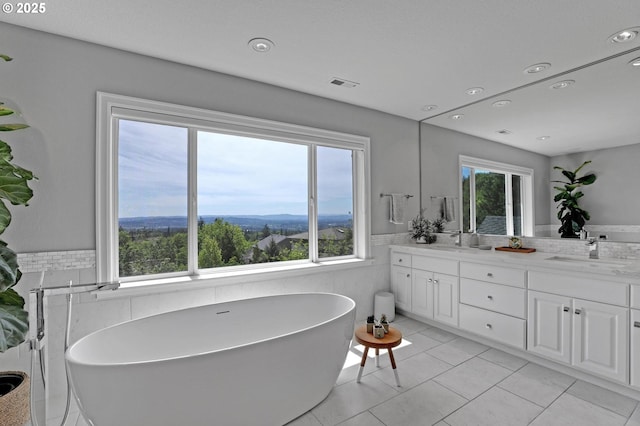 1811 NW Rosefinch Ln, Portland, OR 97229 - full bath featuring double vanity, a freestanding tub, wainscoting, recessed lighting, and tile walls