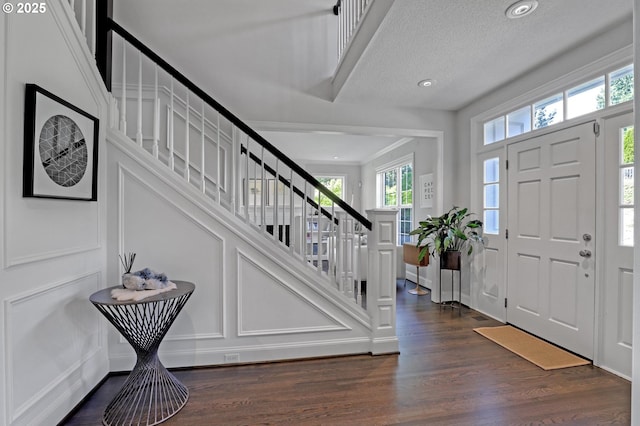 1811 NW Rosefinch Ln, Portland, OR 97229 - entryway featuring stairway, dark wood-style floors, a decorative wall, and recessed lighting
