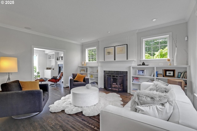 1811 NW Rosefinch Ln, Portland, OR 97229 - living room featuring a fireplace with flush hearth, ornamental molding, wood finished floors, and recessed lighting