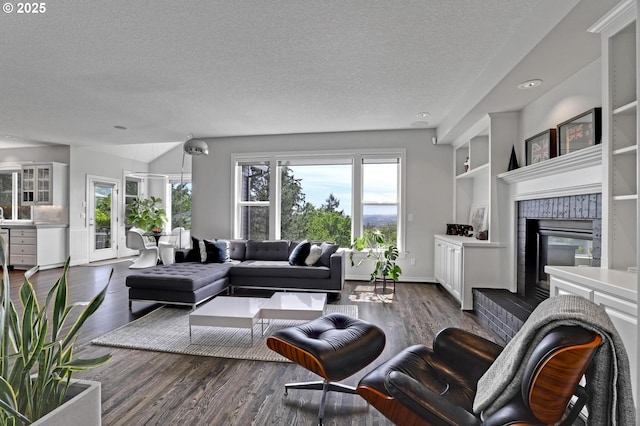 1811 NW Rosefinch Ln, Portland, OR 97229 - living room with a textured ceiling, dark wood-style floors, a brick fireplace, built in features, and baseboards