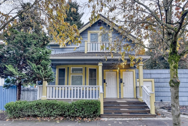5120 NE Glisan St, Portland, OR 97213 - view of front of house featuring covered porch, fence, and a balcony