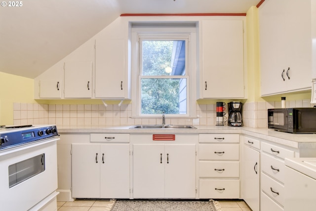 5120 NE Glisan St, Portland, OR 97213 - kitchen featuring white appliances, backsplash, light countertops, white cabinetry, and light tile patterned floors