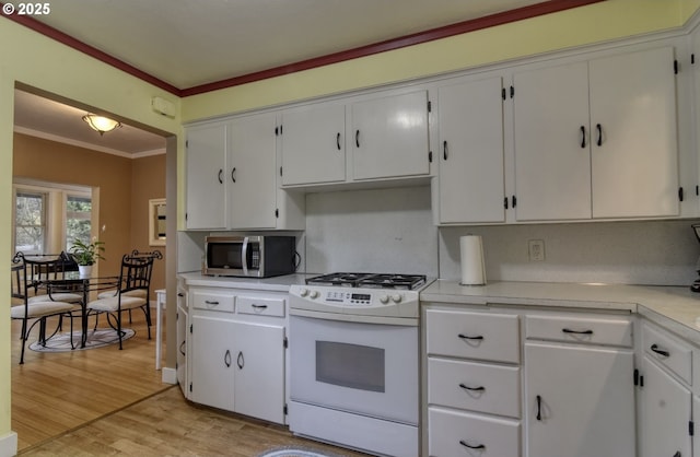 5120 NE Glisan St, Portland, OR 97213 - kitchen with white appliances, a sink, light wood-type flooring, white cabinetry, and crown molding