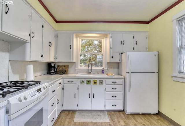 5120 NE Glisan St, Portland, OR 97213 - kitchen featuring stainless steel microwave, white gas range oven, a sink, light wood finished floors, and light countertops