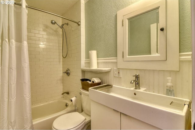 5120 NE Glisan St, Portland, OR 97213 - bathroom featuring a textured wall, wainscoting, a sink, and a decorative wall