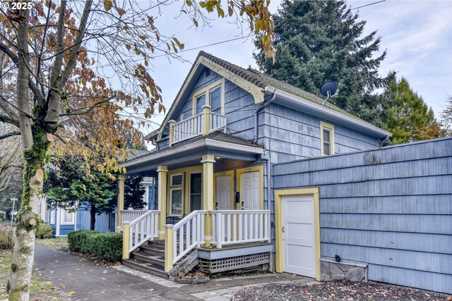 5120 NE Glisan St, Portland, OR 97213 - view of front of home featuring covered porch and an attached garage