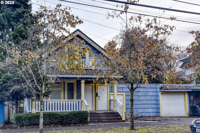5120 NE Glisan St, Portland, OR 97213 - view of front facade featuring a porch, a garage, fence, and a balcony