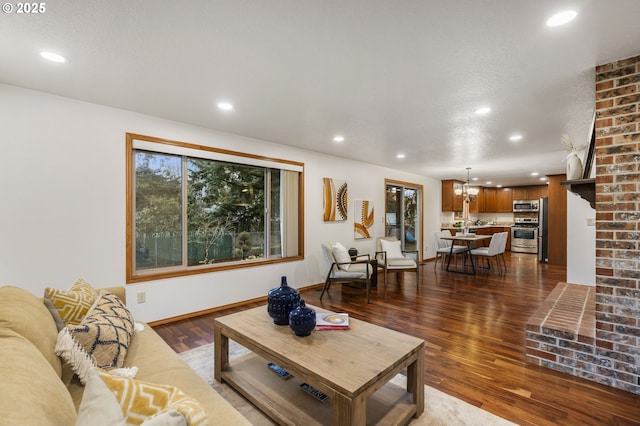 living area with recessed lighting, dark wood-style flooring, a healthy amount of sunlight, and baseboards