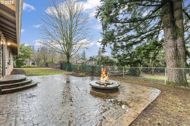 view of patio with an outdoor fire pit and a fenced backyard