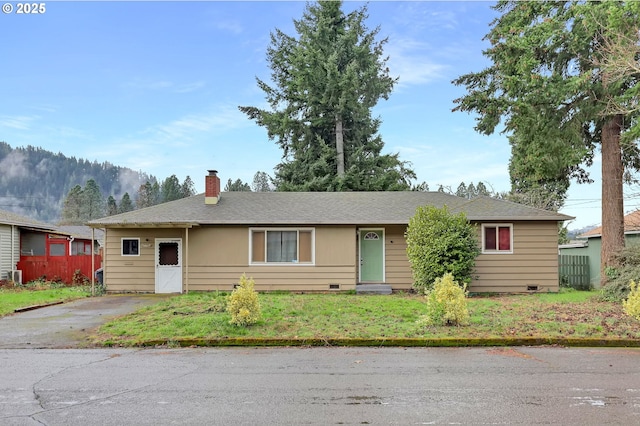 ranch-style house featuring crawl space, fence, a chimney, and a front lawn