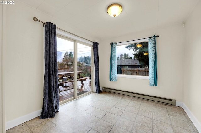 spare room with light tile patterned floors, a baseboard radiator, and baseboards