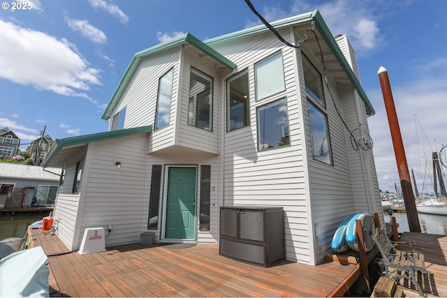 back of house featuring a wooden deck and central AC unit