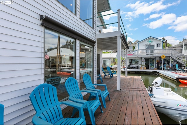 wooden terrace with a water view and a dock