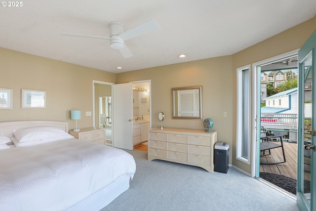 carpeted bedroom with connected bathroom, access to outside, and ceiling fan