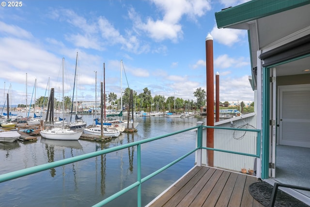 balcony featuring a water view and a boat dock