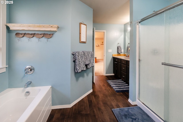 16050 Dick Rd, La Pine, OR 97739 - full bathroom featuring wood finished floors, vanity, a stall shower, and a bath