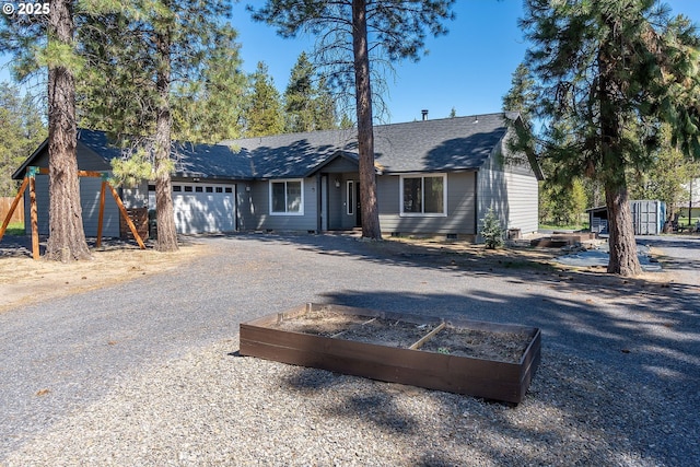 16050 Dick Rd, La Pine, OR 97739 - view of front of home featuring a garden, an attached garage, crawl space, driveway, and roof with shingles