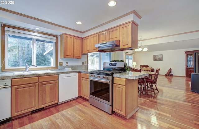 kitchen featuring stainless steel gas range, white dishwasher, tile countertops, and a sink