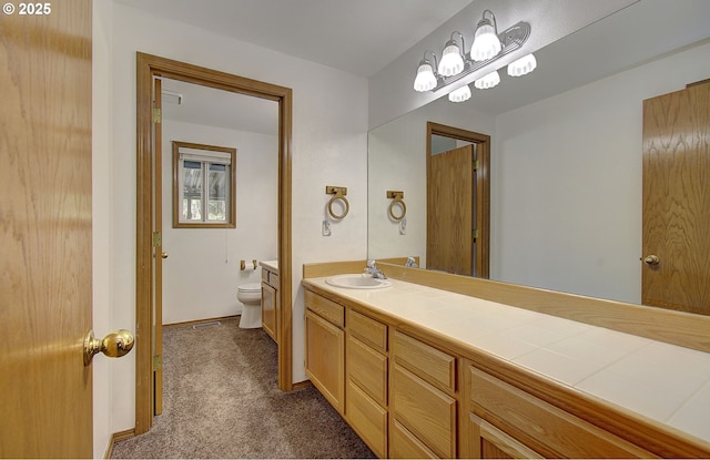 bathroom featuring vanity and toilet