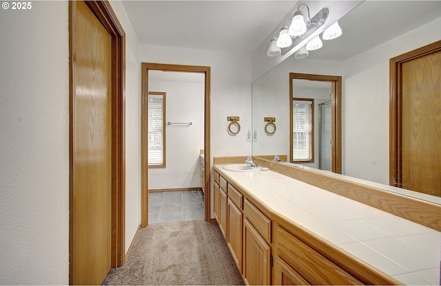 bathroom with a wealth of natural light, vanity, and baseboards