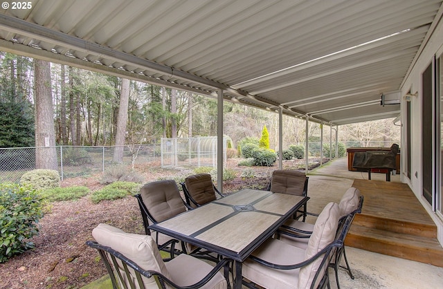 view of patio with outdoor dining area and fence