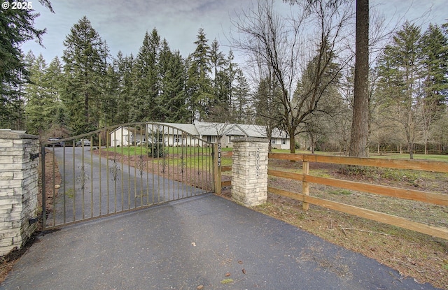 view of gate with a fenced front yard