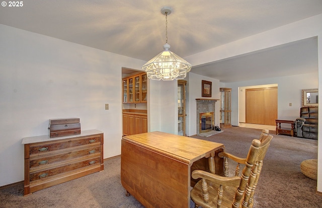 interior space with a chandelier, a fireplace, and baseboards